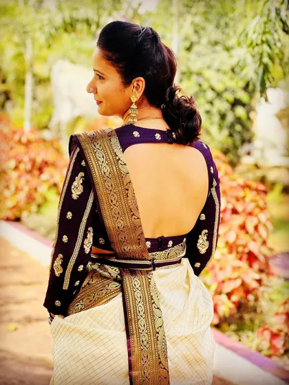 A duplicate image of a client in a deep purple blouse and Kanjeevaram saree.