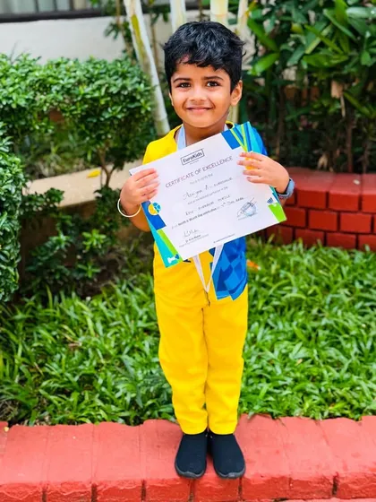 Proudly showing his achievement. Dressed in his team colors, this little boy holds his certificate, a wonderful memento of a day filled with healthy fun and activity.