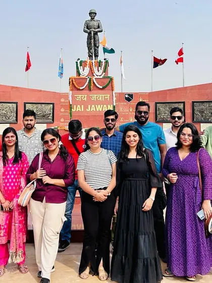 The group paying respects at the Jai Jawan monument in Longewala. Our trips are not just fun but also offer moments of reflection and patriotism.