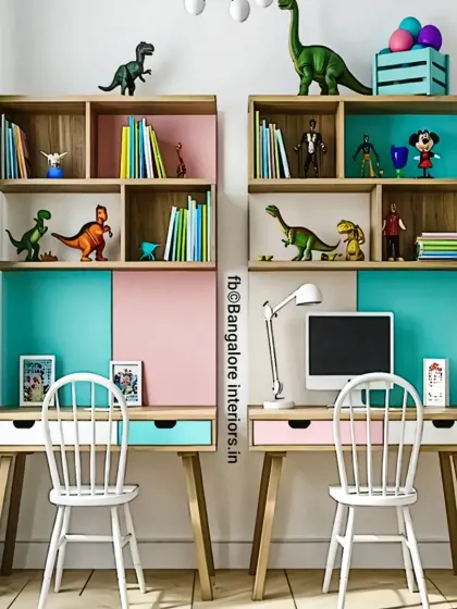 A shared study area for two children, featuring matching desks and chairs. The design uses a cheerful pink and teal color palette with plenty of open shelving for books and toys.