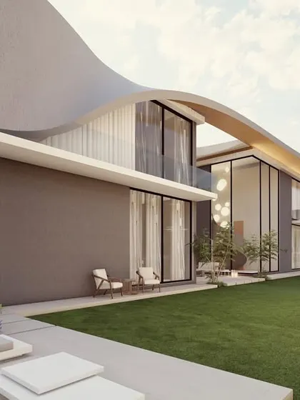 A view of a modern residence with a gently curving roofline that extends over a large lawn. The design emphasizes horizontal lines and a connection to the landscape, with an outdoor lounge area for enjoying the surroundings.
