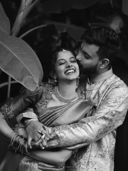 A moment of pure, uninhibited laughter. This black and white engagement photo is timeless, focusing entirely on the couple's joyful connection.