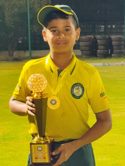 A young player from our boys' team with his championship trophy.