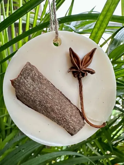 This cinnamon-scented wax sachet is decorated with a real cinnamon stick and star anise. The cinnamon essential oil is also known to help keep bugs at bay.