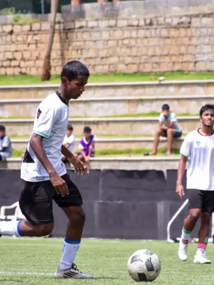 A focused player controls the ball, showcasing the fundamental skills we build from the ground up in our football program.