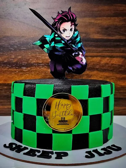 The Demon Slayer! A chocolate truffle cake with a blueberry mousse filling, designed with the iconic green and black checkered pattern from the anime.