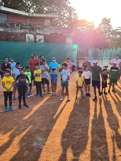The sun sets on a successful tournament day for my junior players. The long shadows on the clay court mark the end of a day filled with effort and passion.