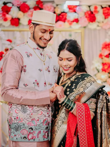 A candid shot of a couple sharing a laugh during their engagement ceremony.