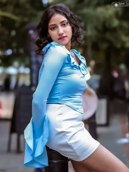 A more posed shot from the same series, with the model leaning against a bollard. The soft focus background keeps the attention on her.