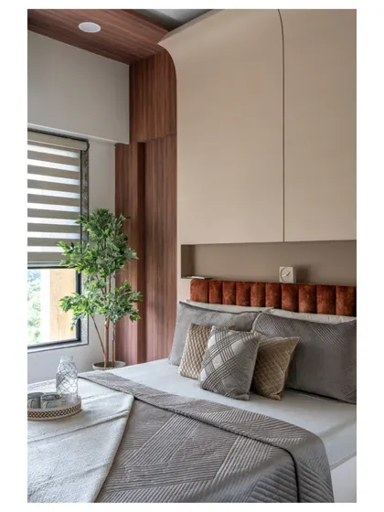 This master bedroom embraces Scandinavian design with its clean lines, expansive windows, and a mix of cozy textures. The curved detail behind the bed adds a soft, organic touch.