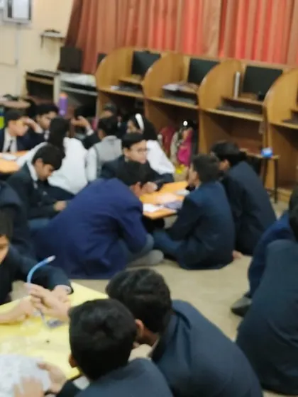 A classroom full of students working in teams during a hands-on session, fostering a collaborative and energetic learning atmosphere.