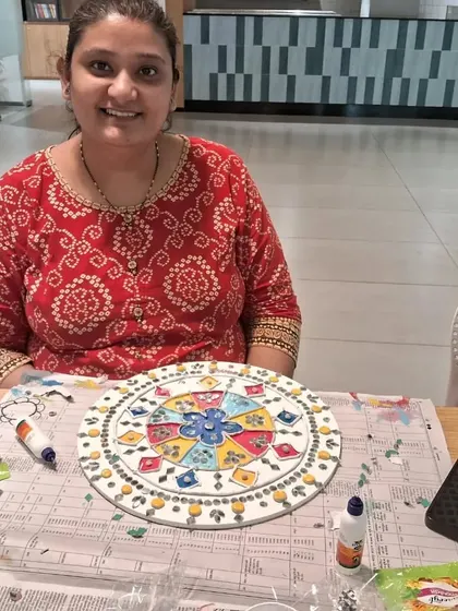 Another happy artist with her completed Lippan art mandala. Each piece is unique, reflecting the individual's style and color choices. It’s a wonderful way to express personality.