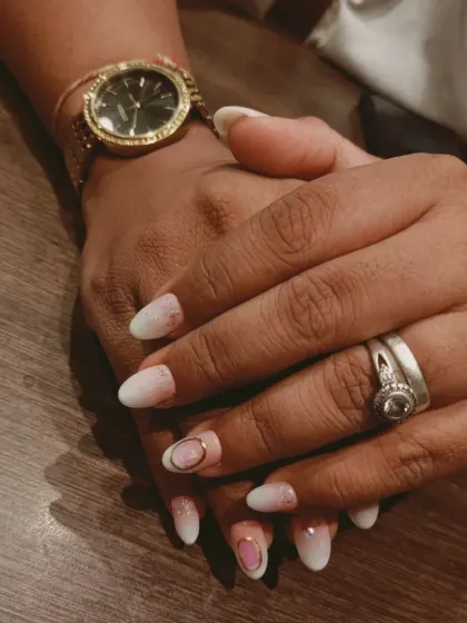 A soft and delicate baby ombre or "boomer" nail, blending from a natural pink base to a soft white tip, with a subtle gold accent.