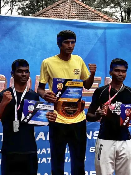 Sumanth on the podium with his championship belt and certificate. This is the result of relentless training and a champion's mindset.