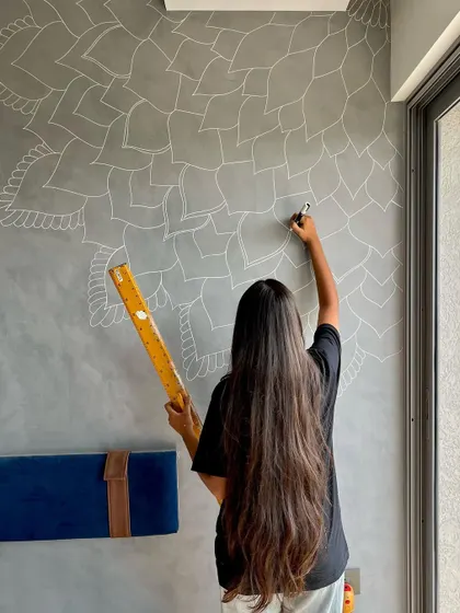 Starting a new mural project. Using a ruler to ensure the foundational grid is perfect is a critical first step for achieving the symmetry that makes mandalas so beautiful.