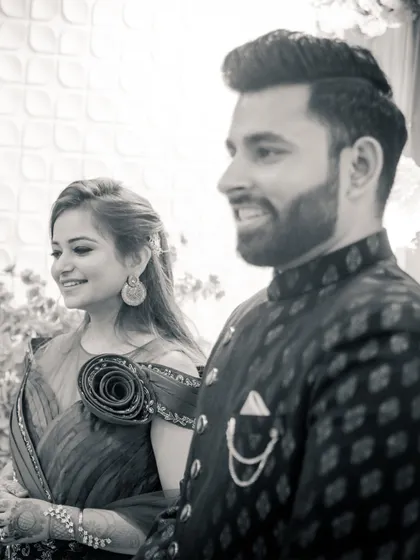 A beautiful black and white candid shot of the couple during their engagement ceremony. Their natural smiles show the happiness of the moment.