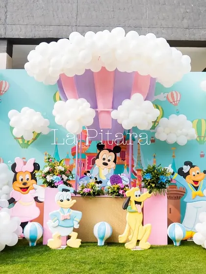 A dreamy main stage with a hot air balloon centerpiece surrounded by clouds made of white balloons, featuring the whole Mickey Mouse gang.