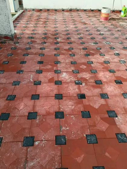We installed these weatherproof outdoor floor tiles on a terrace. The pattern combines classic terracotta with smaller black tiles, creating a durable and decorative surface that is easy to clean.