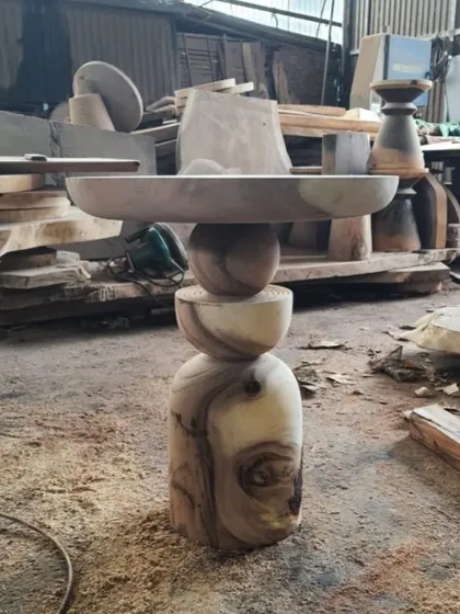 A sculptural side table with a stacked, spherical base.