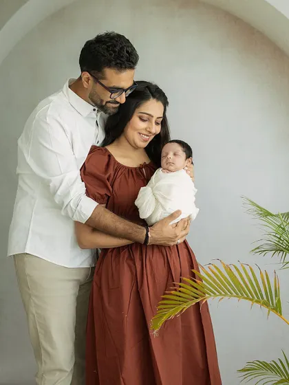 A candid moment of admiration. This shot captures the parents looking lovingly at their newborn, a memory of those fleeting first days.