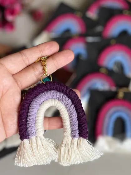 A purple rainbow keychain held in hand. I love this color combination.
