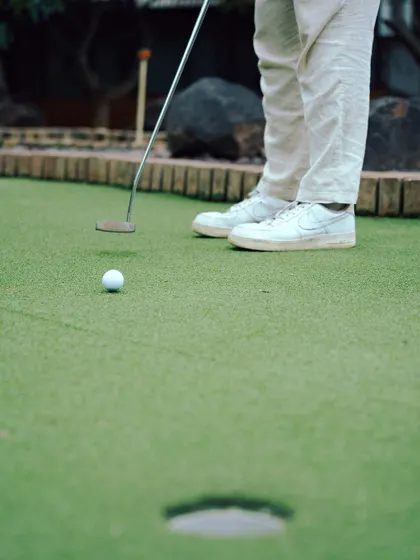A guest lines up a putt on our winding mini-golf course. It's a relaxing outdoor activity that everyone in the family can enjoy together.