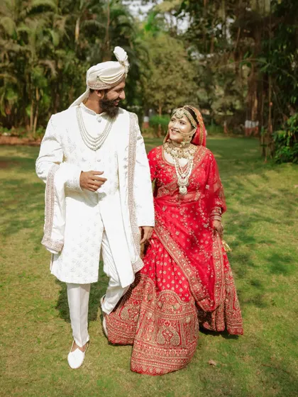 Walking into their future together. A full-length shot that captures the joy and elegance of the couple on their wedding day.