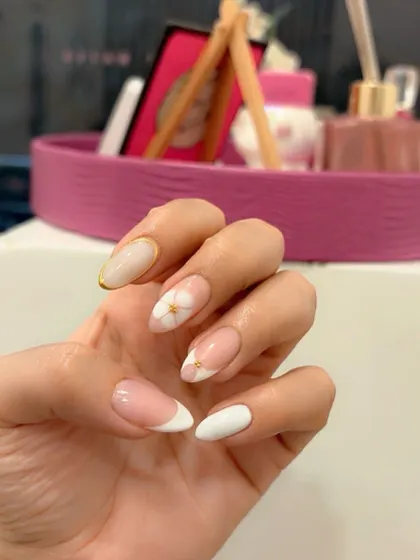 A clear shot of the delicate blossom gel and gold chrome design.