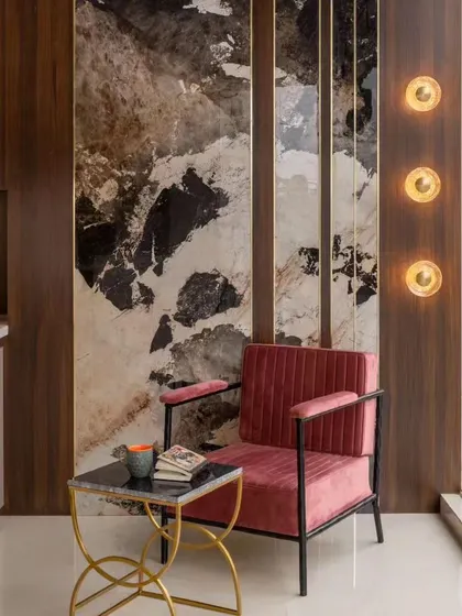 I believe the little details are what make a design truly special. For this cozy reading corner, I used a large format tile with a beautiful marble pattern as a feature wall. Paired with a comfortable chair and warm lighting, it has become one of the most loved spots in the house.