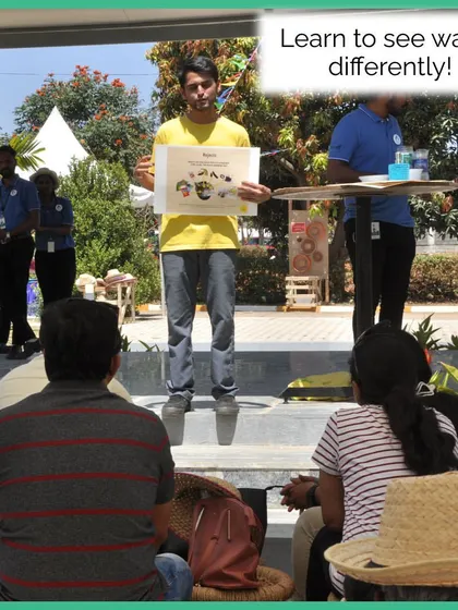 A key part of our workshops is helping people learn to see waste differently. Here, a trainer presents a segregation chart to an audience at an outdoor event.