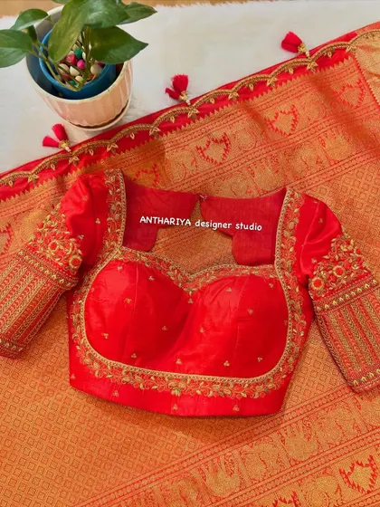 The front of the red blouse, featuring a sweetheart neckline and embroidered sleeves.