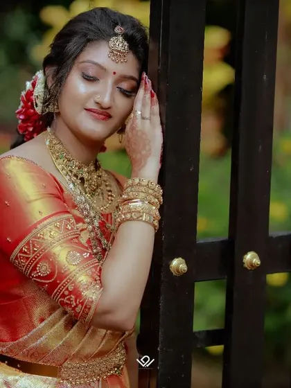 A serene bridal portrait, with the bride leaning against a gate, lost in thought before the ceremony.