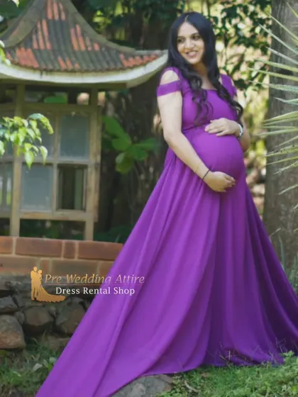 A beautiful solo portrait in our purple off-the-shoulder gown. The simple, elegant design and flowing fabric make it a perfect choice for capturing the beauty of pregnancy in a natural setting.
