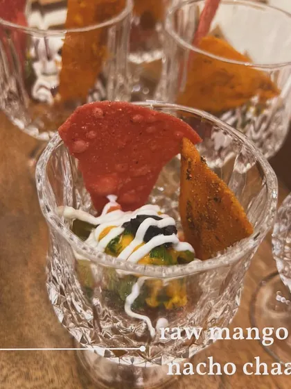 A closer look at the layers in the Raw Mango and Nacho Chaat. You can see the base of tangy salsa, guacamole, and a drizzle of yogurt and sauces.