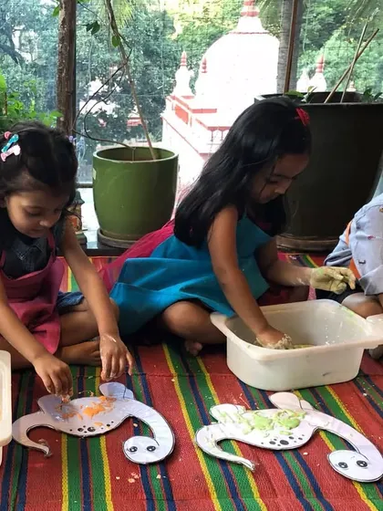 It's always a joy to see kids completely engaged in their creative projects. Here, party guests are working with dough to create turtle crafts, a fun sensory activity that complements the painting.