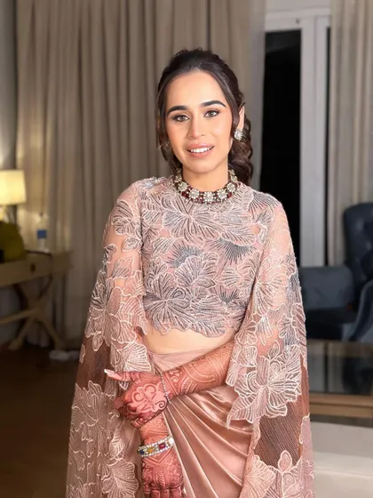 The bride's complete look for her cocktail party. The high ponytail is the perfect choice for her modern, elegant outfit.