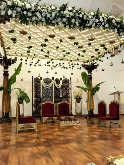 This angle showcases the full structure of our traditional mandap, with sturdy wooden pillars, auspicious banana plants, and a beautifully carved screen, blending cultural heritage with sophisticated floral artistry.