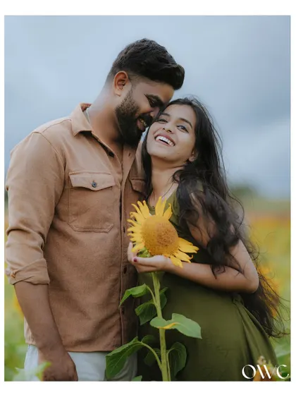 A candid moment of laughter in a field of sunflowers. Our pre-wedding photography focuses on capturing your genuine connection and happiness.