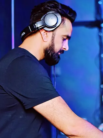 A close-up of me focused on the mix during a set. This captures the concentration it takes to be a professional DJ.