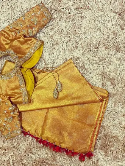 A stunning all-gold blouse with silver and gold hand embroidery, perfect for a grand celebration.