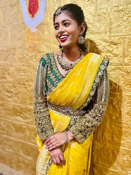 This model is wearing a beautiful kundan set with a yellow saree for a festive look.