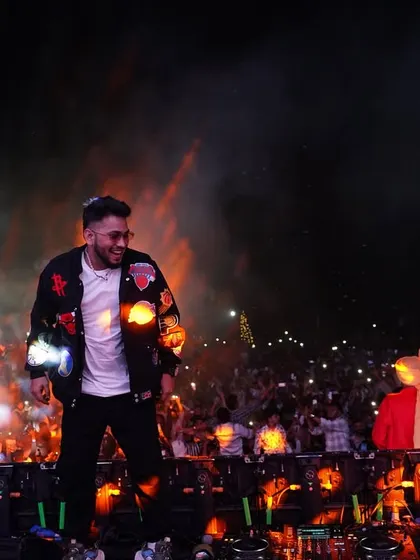 A candid moment of me smiling on stage, surrounded by pyro and a happy crowd. This is why I do what I do.