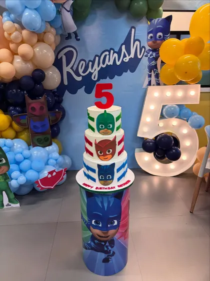 The PJ Masks cake in its full party setup! It fit perfectly with the amazing decorations and the light-up number 5. This was a delicious Chocolate-Salted Caramel cake.