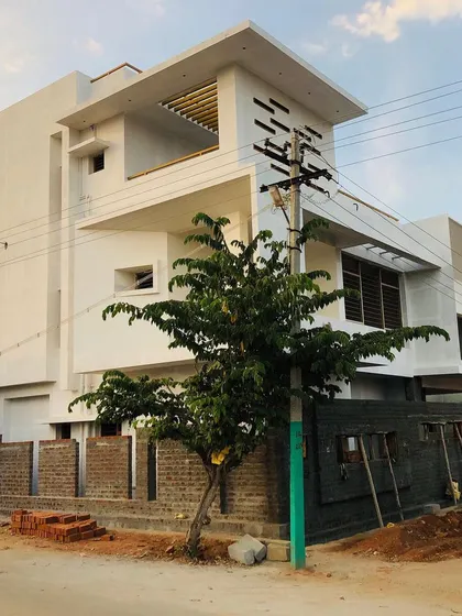 The project midway through construction, with the brickwork and basic form complete. This stage is where the architectural vision starts to become a physical reality, showing the transition from blueprint to building.