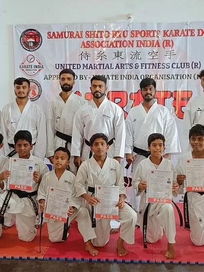 The full group of black belt candidates and their instructors after a rigorous belt grading exam.