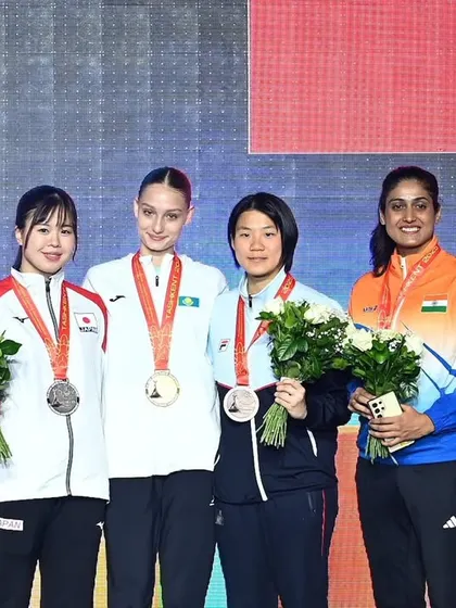 Our flag on the victory stand at the Asian Senior Karate Championship. Bhuvaneshwari Jadhav holds her bronze medal, a testament to her hard work and the high-performance training she received through our program.