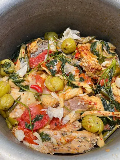 A pot of our fish curry with bitter eggplant, tomatoes, and wild herbs. This is a typical Naga household dish, boiled together to create a comforting and nutritious meal.