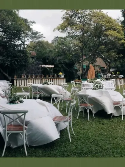 A view of the outdoor dining setup before the brunch began. The tables are covered to protect them, showing the practical preparations behind a beautiful event.