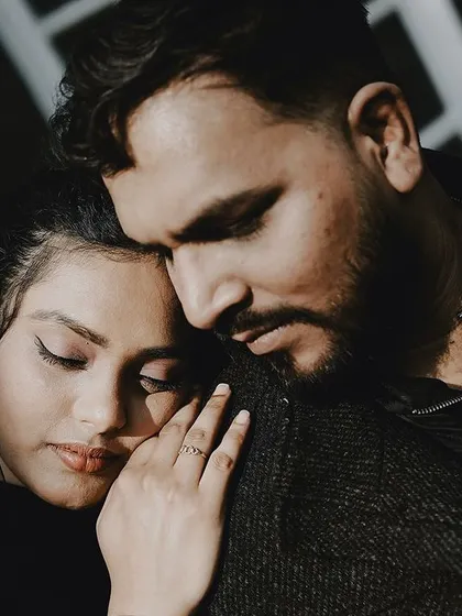 A close-up of a tender embrace, focusing on the emotion and connection between the couple.