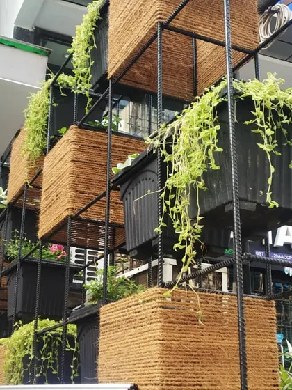 This is a simple yet beautiful concept for a storefront. We used a custom-built metal frame with coir-wrapped planters to create a multi-level vertical garden that is both eye-catching and budget-friendly.